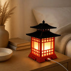 Halyvira Japanese pagoda LED table lamp glowing on a bedside table