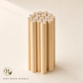 Halyvira bundle of pine wood round dowels on warm cream studio background (updated)