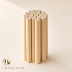 Halyvira bundle of pine wood round dowels on warm cream studio background (updated)
