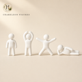 Halyvira four white chameleon figurines on warm cream studio background (updated)