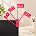 Four example pink pivoting monitor flags with white status messages and a headphones icon — illustrative preview
