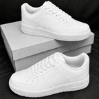 Pure white low-top casual sneakers on plain boxes